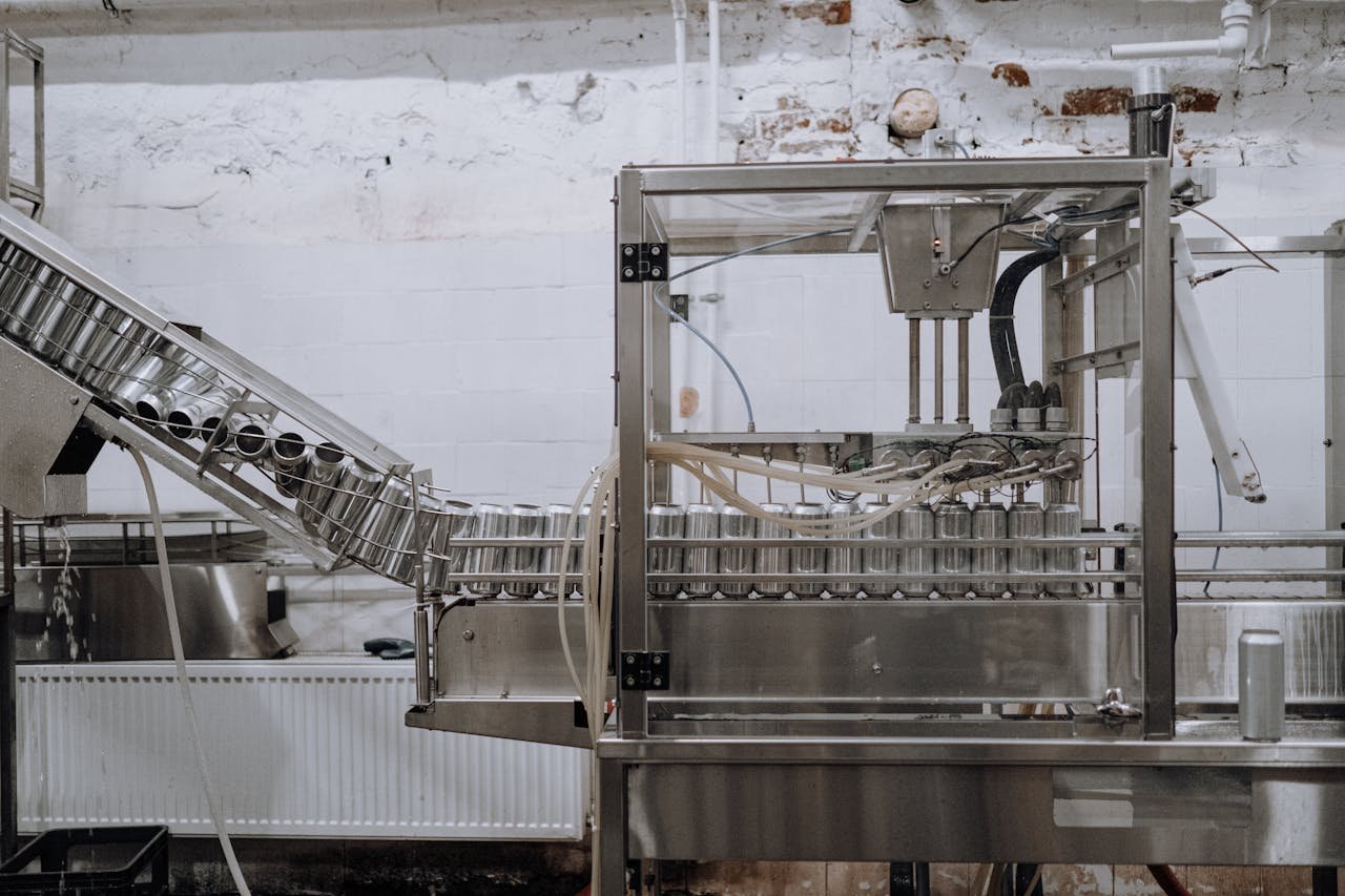 Home Automated beverage can packaging in a modern factory setting.